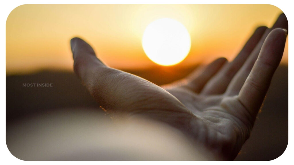 Helping hand under sunrise.