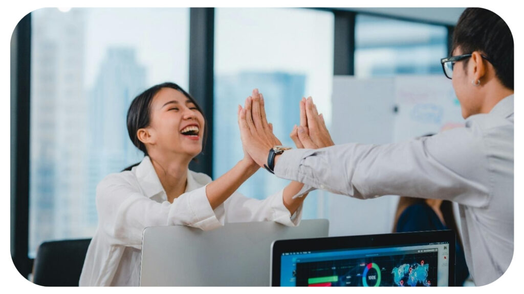 two employees enjoying the project success in office.