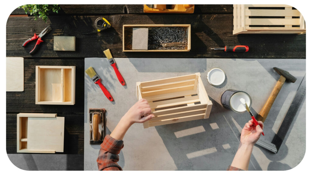 top view of unrecognizable woman making and painting wooden boxes, small business and desktop concept.