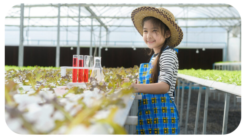 A happy cute girl learning and studying in hydroponic greenhouse farm.