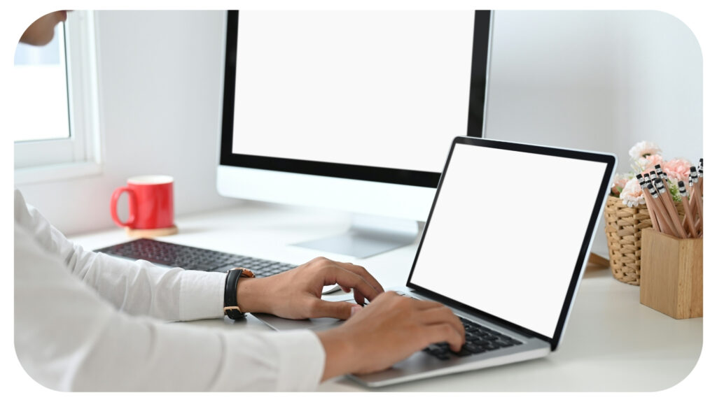 hands typing on laptop with blank screen on work.