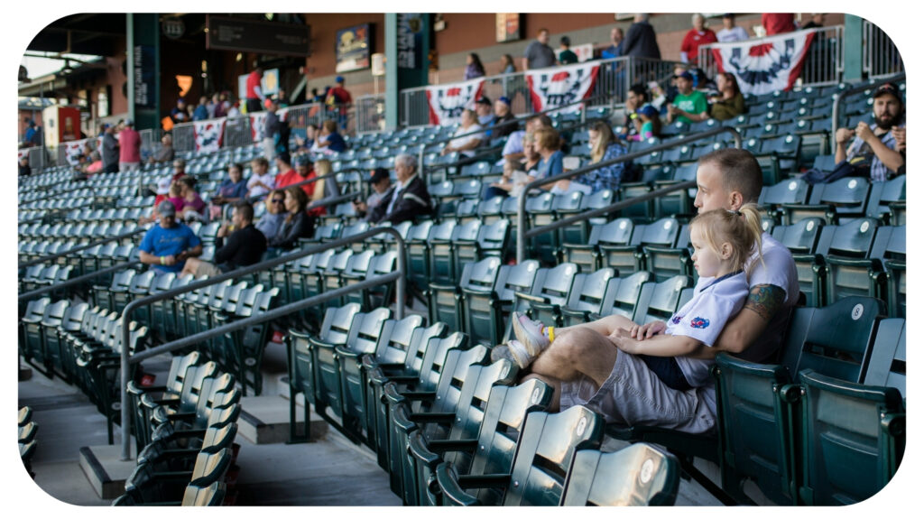 man sitting on green theater chair.