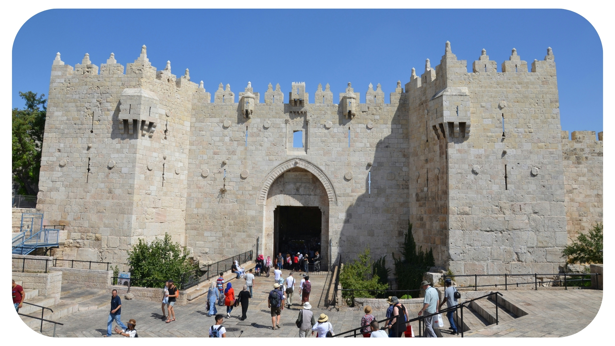 a group of people standing in front of a castle.