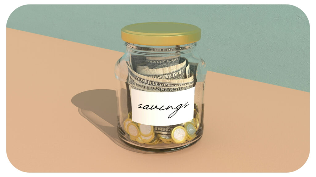 a jar filled with money sitting on top of a table.