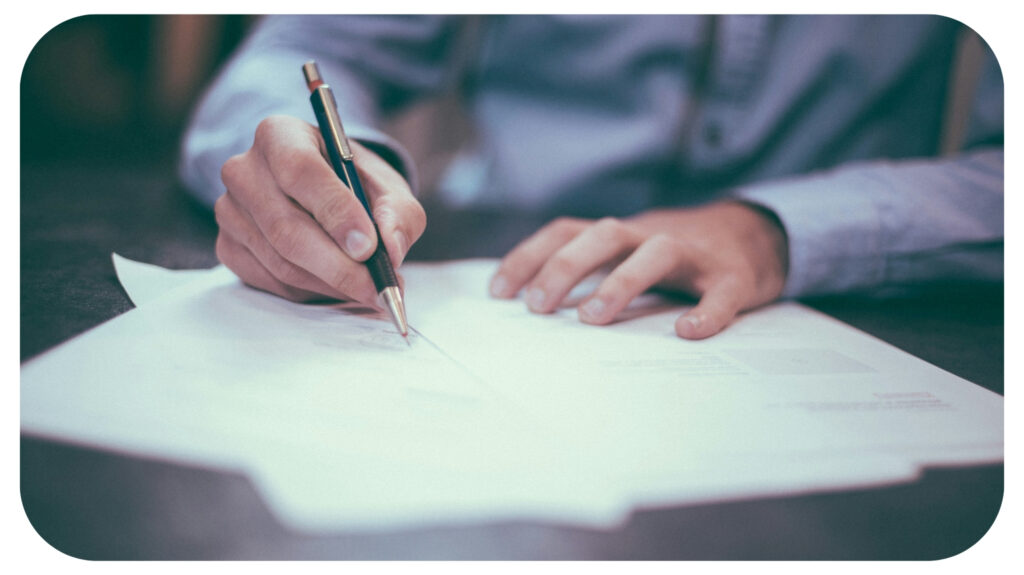 man writing on paper.