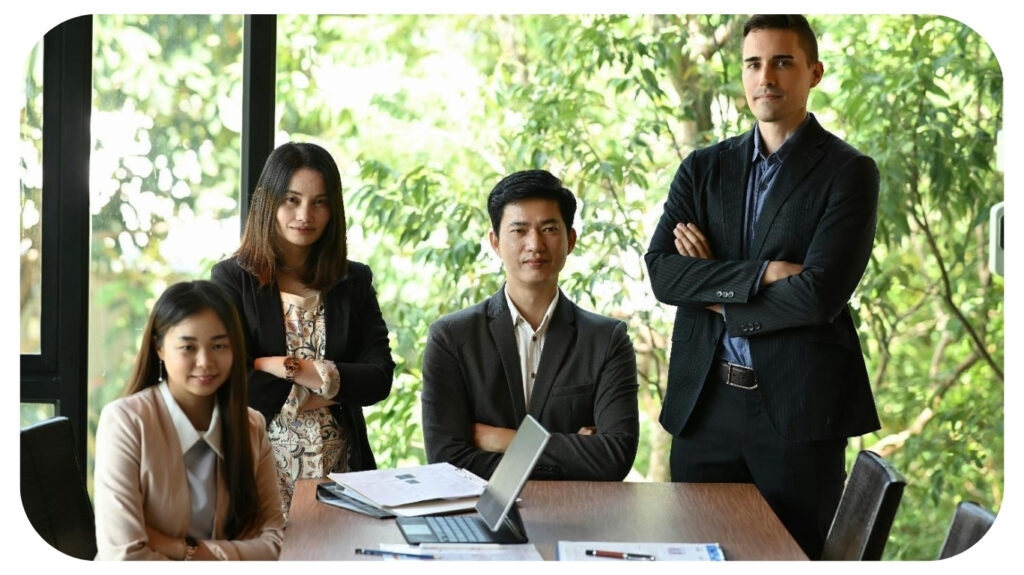 Group of successful business people at modern office smiling and looking at camera.