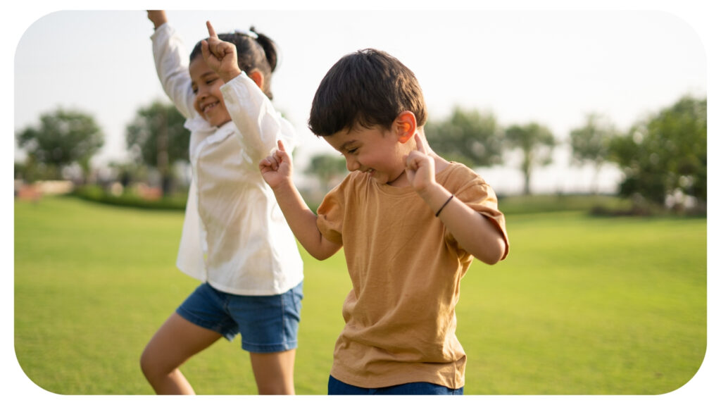 Happy Children Dancing Together in the Park.