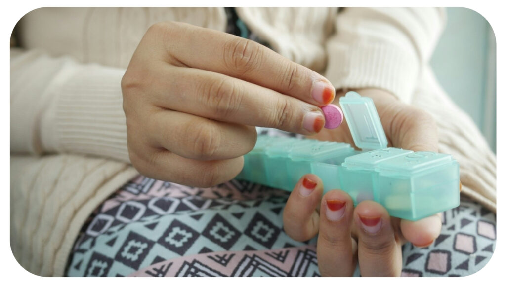 person holding white and green plastic container.