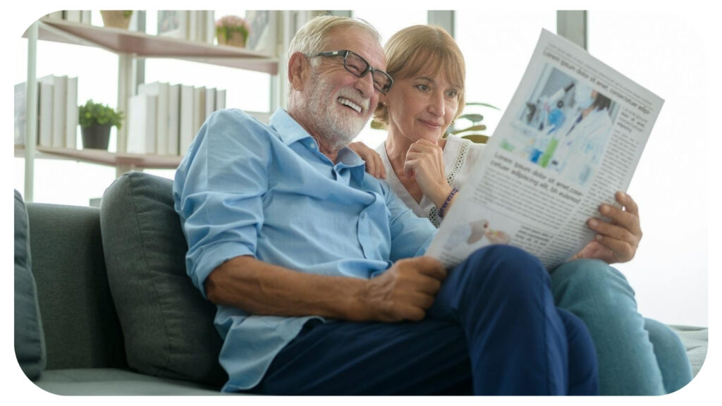 Happy Couple Caucasian senior are relaxing and reading newspaper in living room.