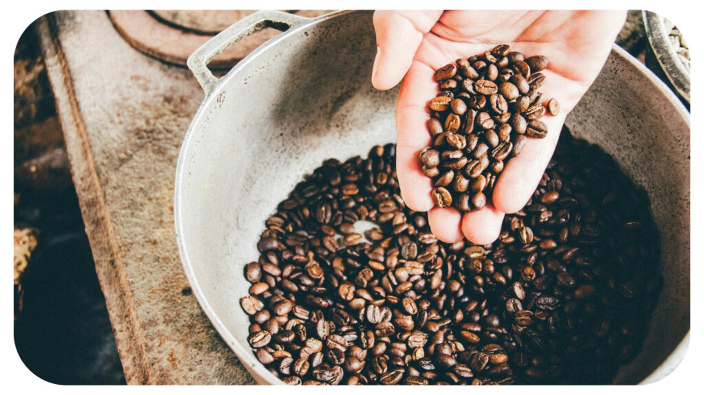 coffee beans on gray steel wok.